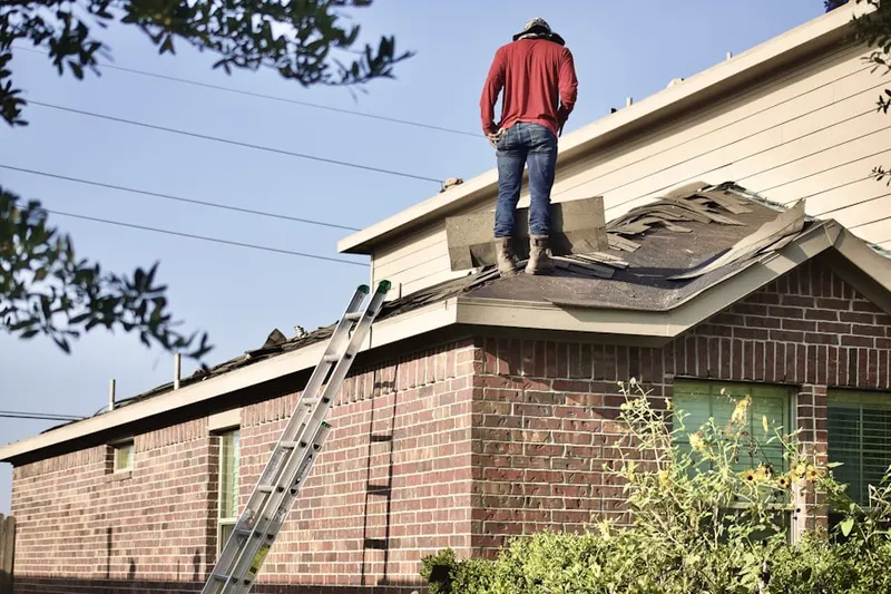 Professional roofer working on a residential roof in Middle